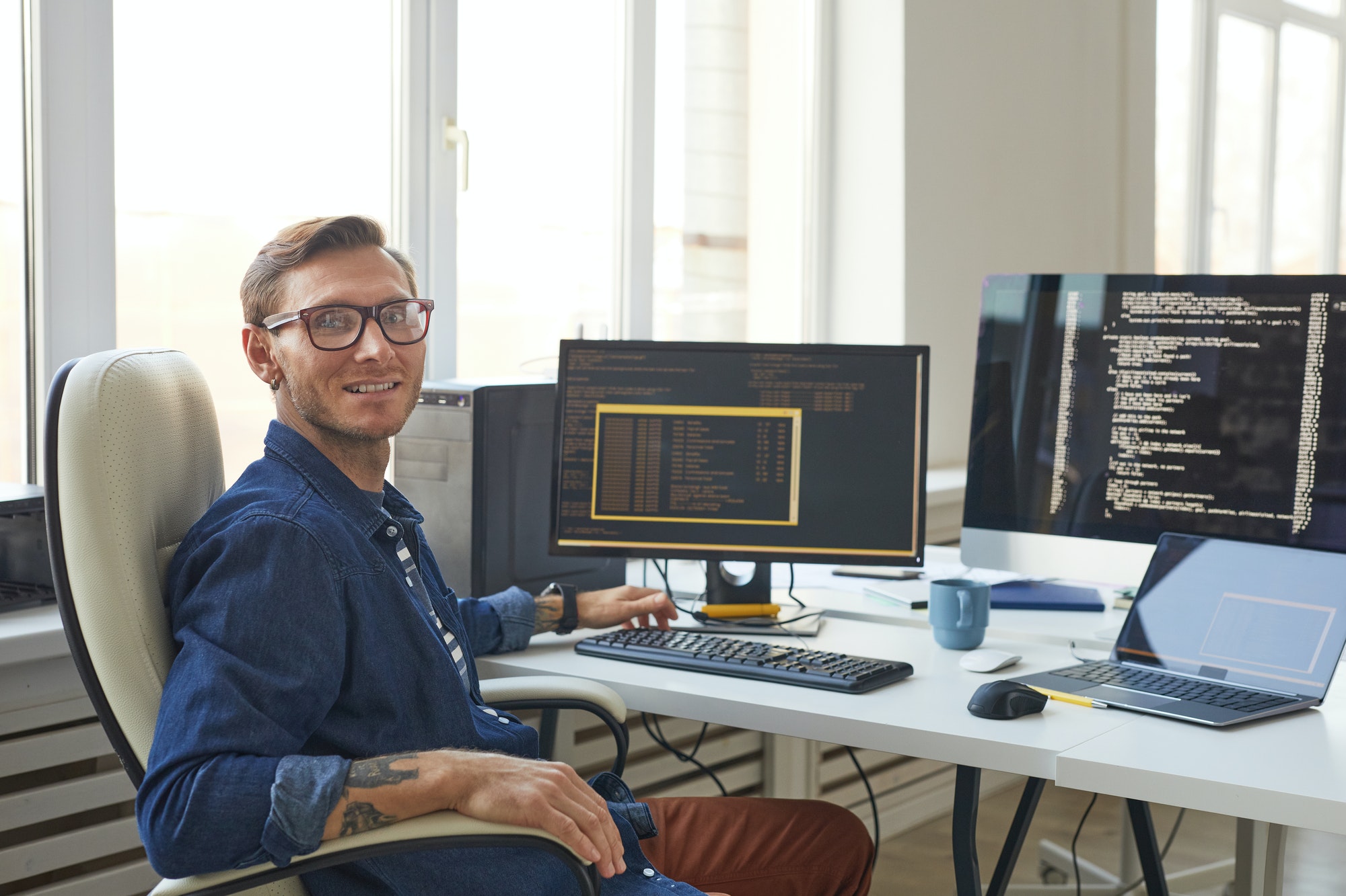 Portrait of IT Programmer Using Computers with Code on Screen