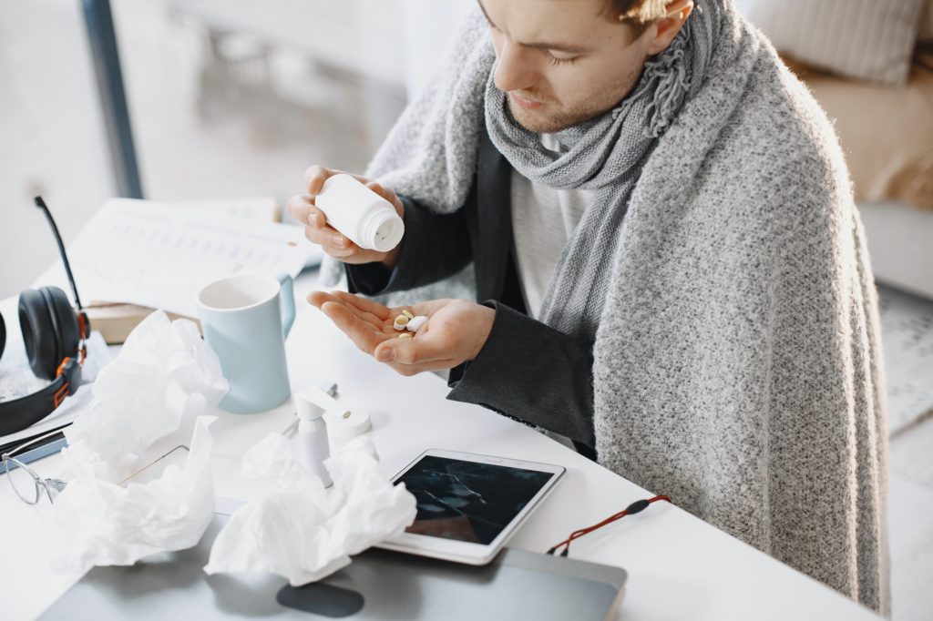 Young man ill with flu in office